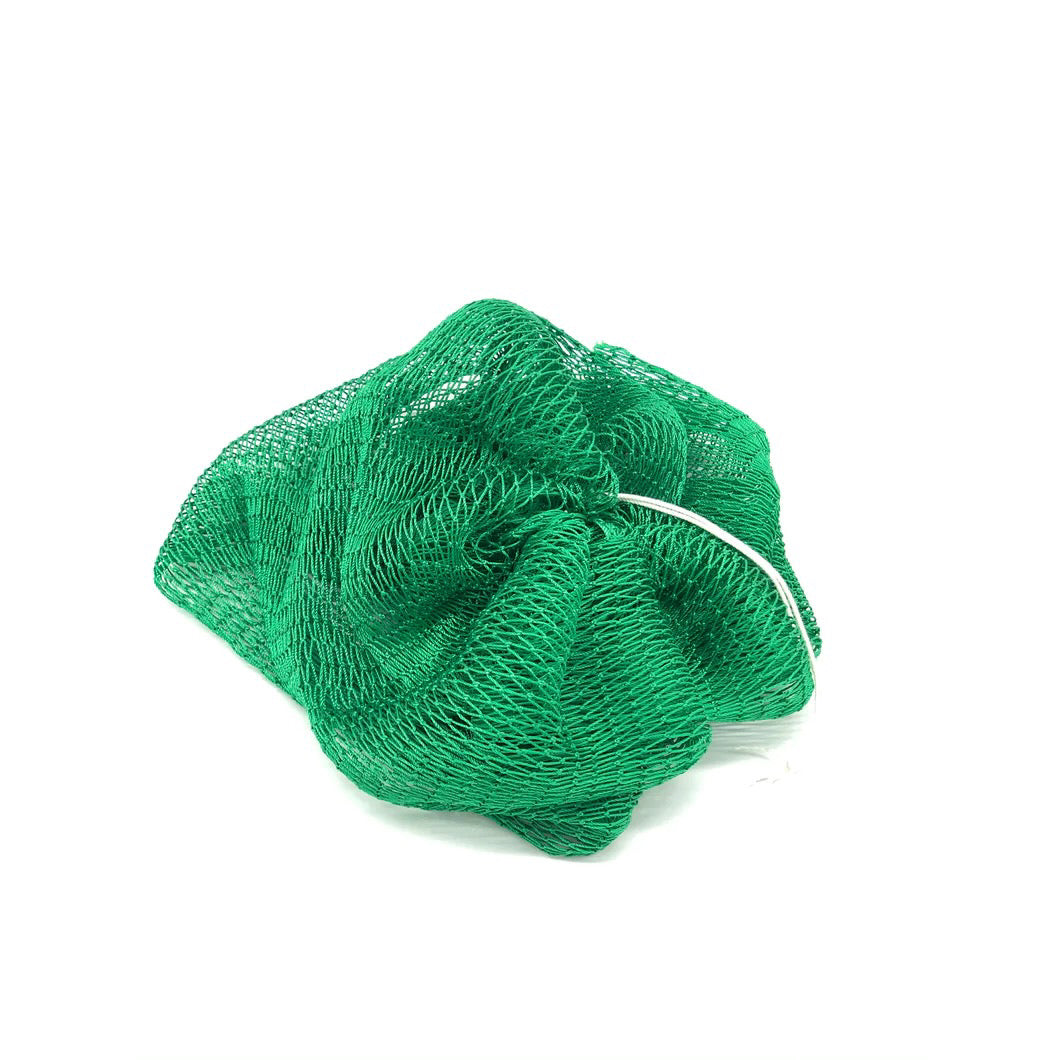 Green African Exfoliating Sponge arranged on a Surface