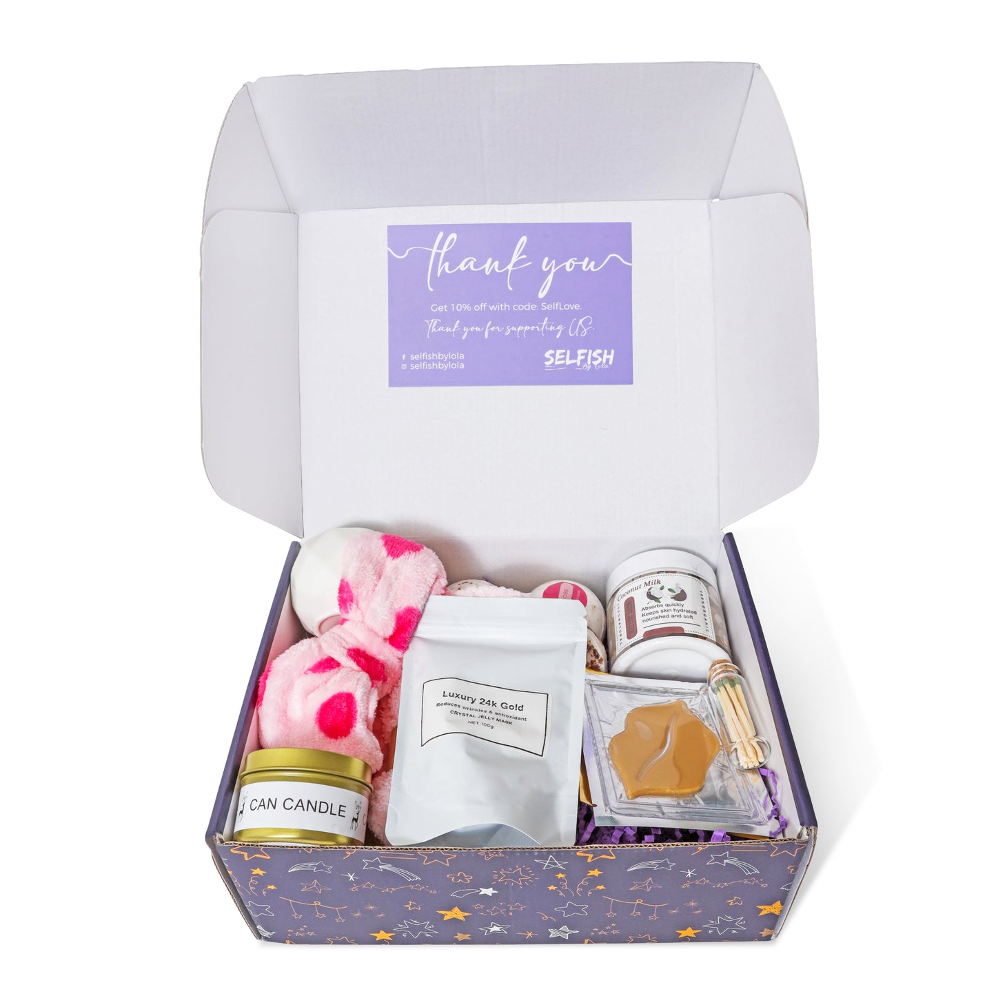 A selection of luxurious self-care products arranged inside a Selfish By Lola self-care gift box